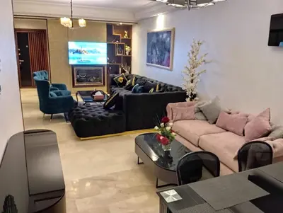 a living room with a couch and a table at Appartement Casablanca vue sur mer in Casablanca