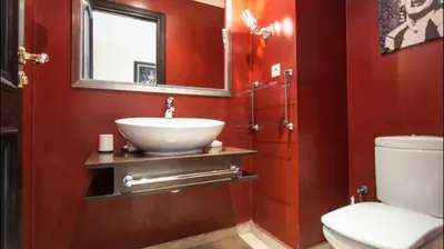 a bathroom with a sink and a toilet and a mirror at Luxueux Appart Au Triangle D'Or Casablanca in Casablanca