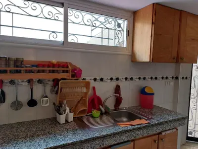 a kitchen counter with a sink and a window at Dream House Sidi Rahal Beach in Sidi Rahal
