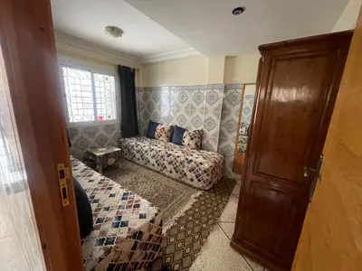 a living room with a couch and a window at Dream House Sidi Rahal Beach in Sidi Rahal