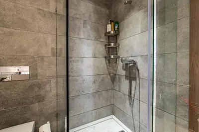 a bathroom with a shower with a glass door at COMFORTABLE & ELEGANT FLAT IN A LIVELY PLACE by ShortstayMaroc in Casablanca