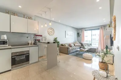 a kitchen and living room with a couch and a table at COMFORTABLE & ELEGANT FLAT IN A LIVELY PLACE by ShortstayMaroc in Casablanca