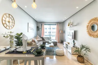 a living room with a table and a couch at COMFORTABLE & ELEGANT FLAT IN A LIVELY PLACE by ShortstayMaroc in Casablanca