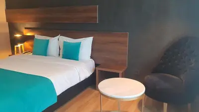 a hotel room with a bed and a chair at Yto boutique Hotel in Casablanca