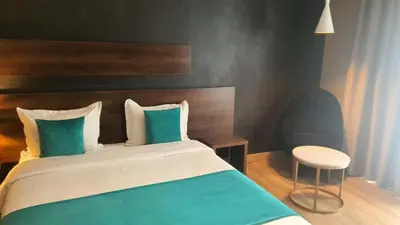 a bedroom with a bed with green and white pillows at Yto boutique Hotel in Casablanca