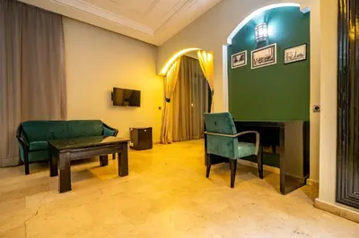 a room with a couch and a table and a fireplace at Diwan Casablanca Hotel & Spa in Casablanca