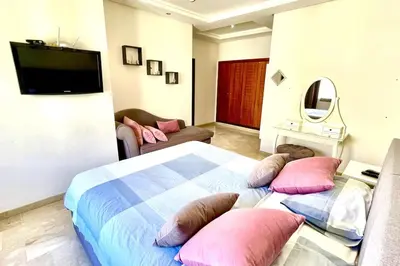 a bedroom with a large bed with pillows on it at Taj nouaceur aéroport Mohamed V in Nouaseur