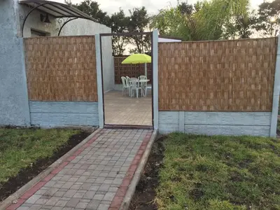 an open door to a patio with a table with an umbrella at Palm Grove Farm in Tit Mellil