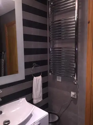 a bathroom with a sink and a mirror and a towel at luxury apartment in Marina Casablanca in Casablanca
