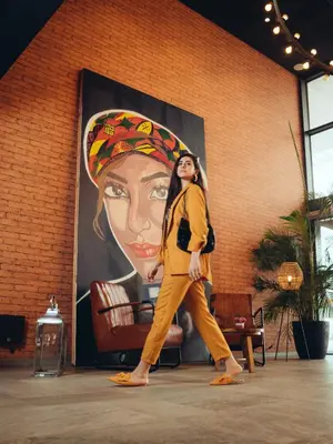a woman walking in front of a large painting of a woman at ONOMO Hotel Casablanca Sidi Maarouf in Casablanca