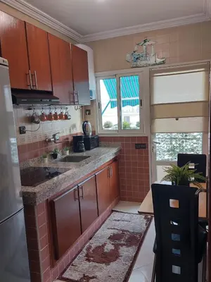 a kitchen with a sink and a counter top at Appartement avec terrasse au cœur du centre-ville de Rabat in Rabat