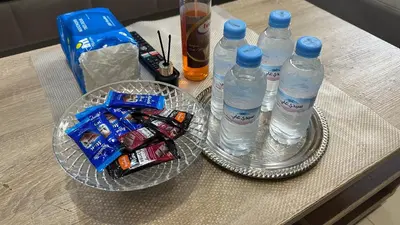 a table with two plastic bottles of water and snacks at Joli appartement Casablanca ain sebaa in Casablanca