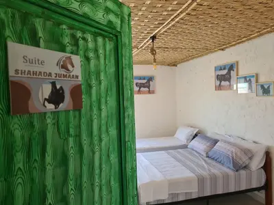 a green tent with a bed in a room at Gîte équestre Balade plage petit déjeuner au bord de la piscine in Azemmour