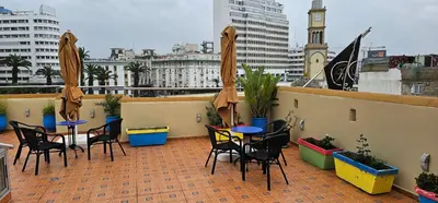 a patio with tables and chairs on a roof at Ryad 91 in Casablanca