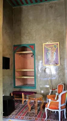 a room with a mirror and two chairs and a table at Ryad 91 in Casablanca