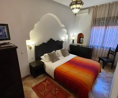 a bedroom with a large bed with a colorful blanket at Dar Tahra in Casablanca