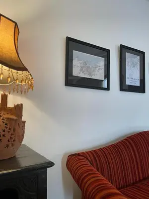 a living room with a couch and pictures on the wall at Dar Tahra in Casablanca