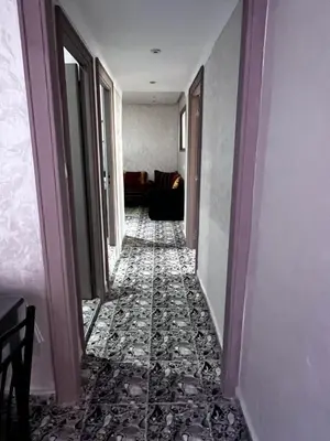 a hallway of a room with a floor of tiles at le spatieux in Casablanca