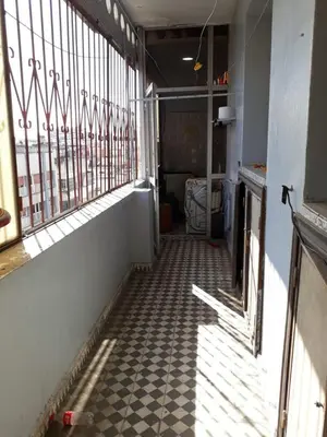 a hallway with a window and a checkered floor at le spatieux in Casablanca