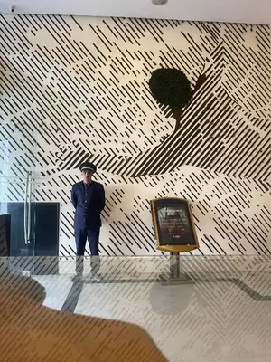a man standing in front of a wall with a painting at WINDSOR HOTEL CITY CENTER in Casablanca