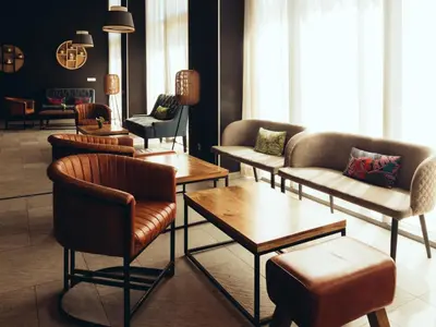 a lobby with couches and chairs and tables at ONOMO Airport Casablanca in Casablanca
