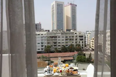 a table with plates of food on top of a building at Mid Town Hotel Casablanca in Casablanca