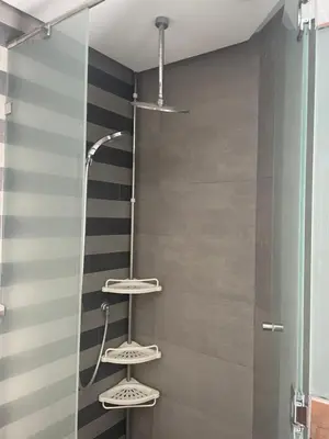 a shower with three shelves in a bathroom at Belle-Vue sur Mer à Casa-Marina 9éme étage in Casablanca