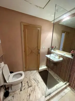 a bathroom with a toilet and a sink and a shower at Late&Early Flight cozy Apartment in Nouaseur