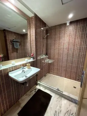 a bathroom with a sink and a shower at Late&Early Flight cozy Apartment in Nouaseur