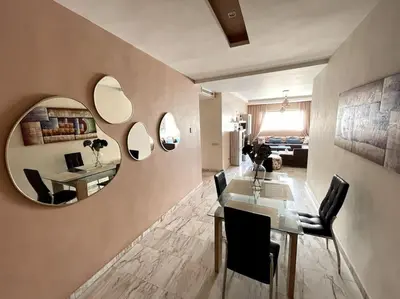 a dining room with a table and a mirror at Late&Early Flight cozy Apartment in Nouaseur