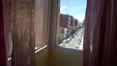 a view of a city street from a window at Faridi vacancy appartment in Casablanca