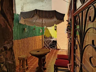 a room with a table and an umbrella at Appartement a casablanca in Casablanca