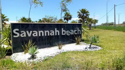 a sign for savannah beach in a park at Dar Lazraq in Sidi Rahal