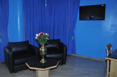 a room with two chairs and a vase with flowers on a table at HOTEL DELTA ATLAS in Casablanca