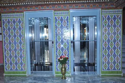 a room with two doors with a vase of flowers at HOTEL DELTA ATLAS in Casablanca