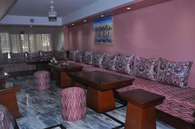 a living room with a large couch and tables at HOTEL DELTA ATLAS in Casablanca