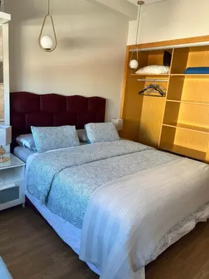 a bedroom with a large bed with a red headboard at Hadil Room in Rabat
