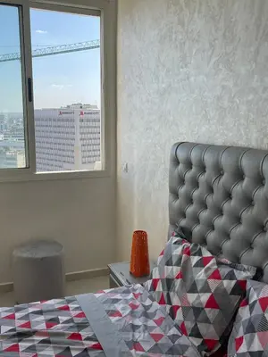 a bedroom with a bed and a large window at Melines in Casablanca