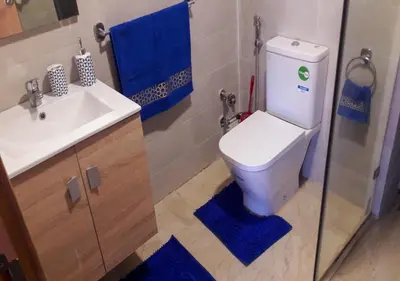 a bathroom with a toilet and a sink at Charmant Appartement avec une vue imprenable in Tamaris