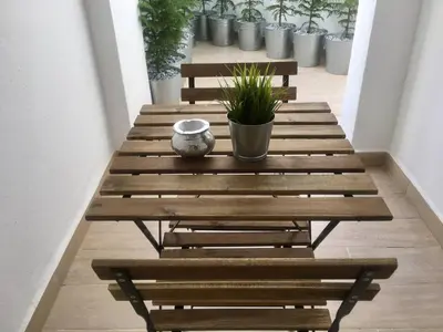 a wooden table with a plant sitting on top of it at Appartement près de Novotel face au parc WELCOME STAY in Mohammedia