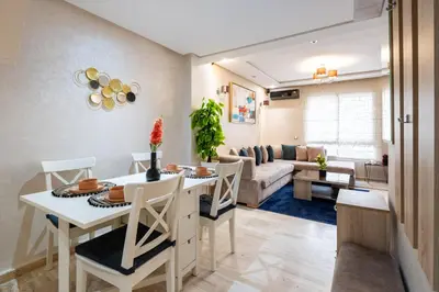 a kitchen and living room with a table and chairs at Casa Lucia Family Flat Optical Fiber in Rabat