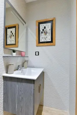 a bathroom with a sink and a mirror at Casa Lucia Family Flat Optical Fiber in Rabat
