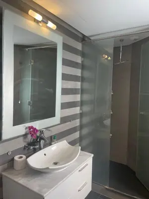 a bathroom with a sink and a shower with a mirror at Beautiful View on the sea at Casa-Marina 13 in Casablanca