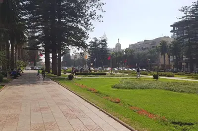 a sidewalk in a park with trees and grass at A 200m de la Plage, du Haut Standing au coeur du Parc in Mohammedia