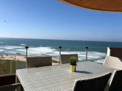 a table with chairs and a view of the beach at KEEP CALM AND THINK OF THE SEA, MARINA!! in Casablanca