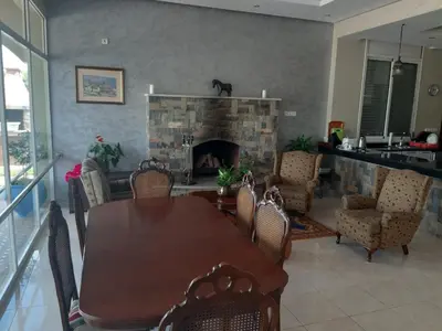 a dining room with a table and a fireplace at Riad TANJIL in Casablanca