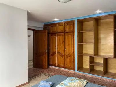 a room with wooden cabinets and a bed in it at Luxury Villa at Ain-Diab in Casablanca
