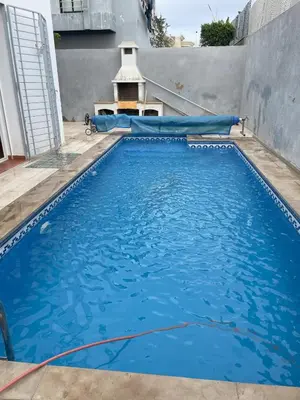 a large blue swimming pool with a water slide at Luxury Villa at Ain-Diab in Casablanca