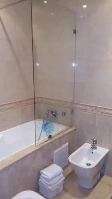 a bathroom with a tub and a toilet and a sink at Appartement de luxe in Casablanca