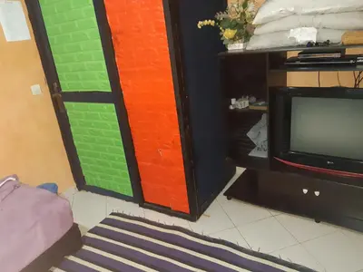 a room with a tv and a colorful wall at Aznavour room in Casablanca